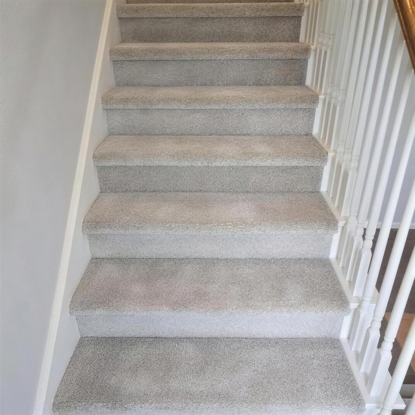 Newly carpeted staircase with each tread wrapped and fastened