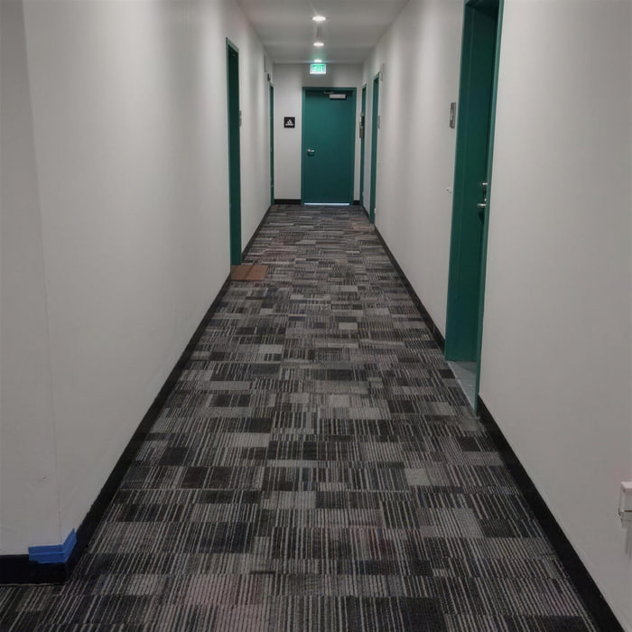 Patterned commercial carpet tile installed along a building corridor