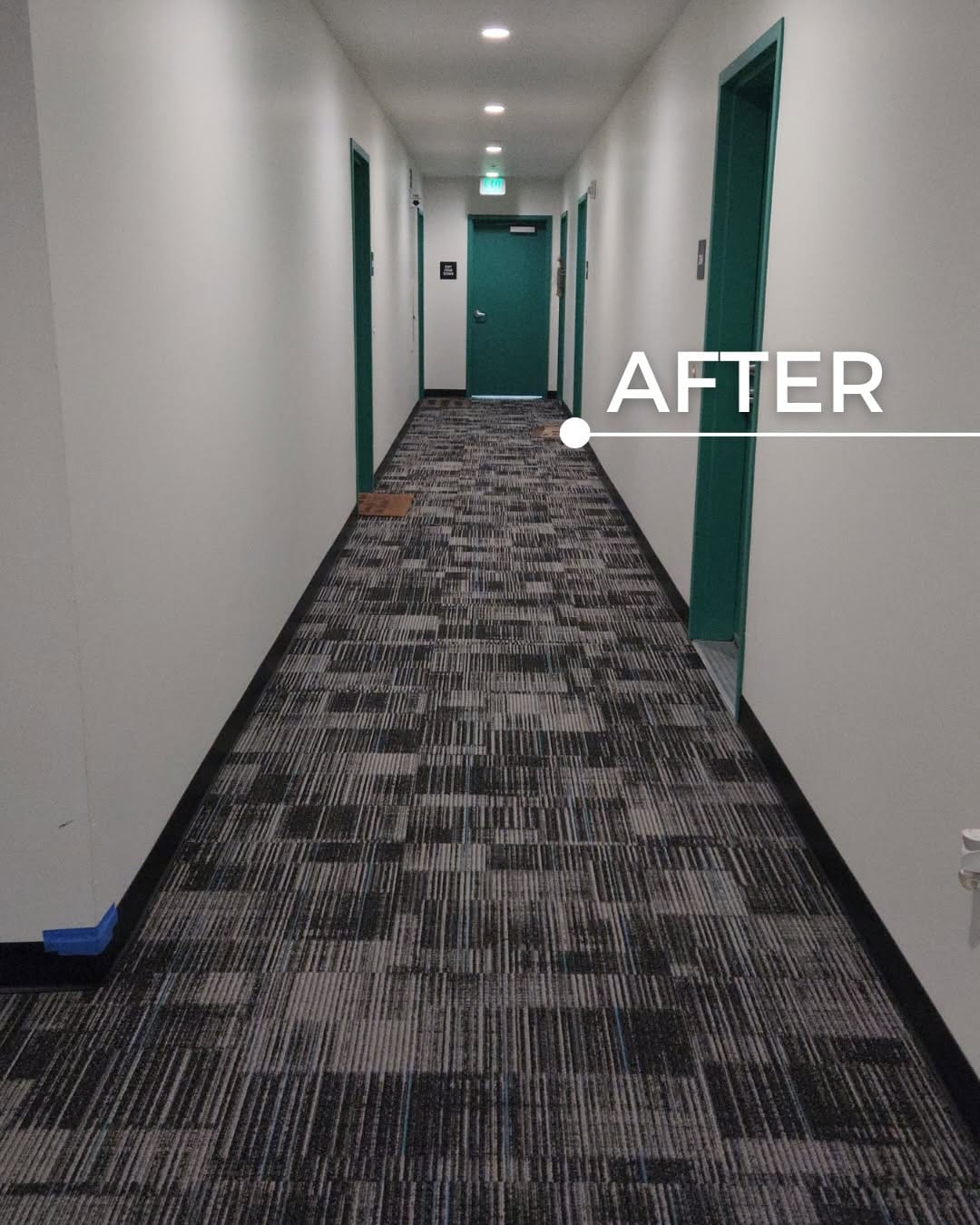 The same corridor finished in patterned commercial carpet tile