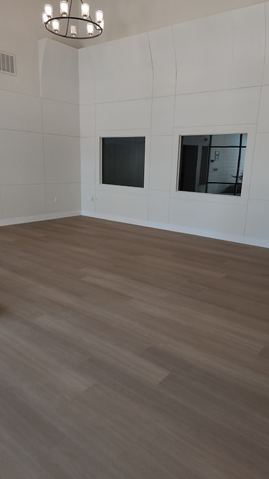 Commercial meeting room with dark vinyl plank flooring