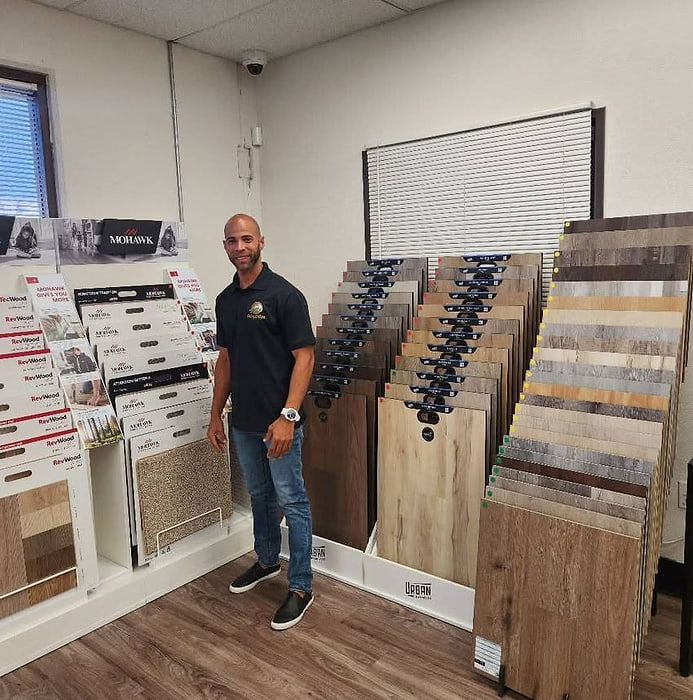 Golden Floors owner among hardwood, laminate and vinyl plank samples at a supplier showroom
