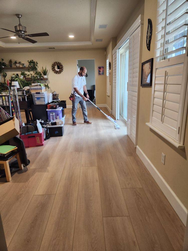 Wood-look plank flooring running the length of a Sacramento hallway after installation