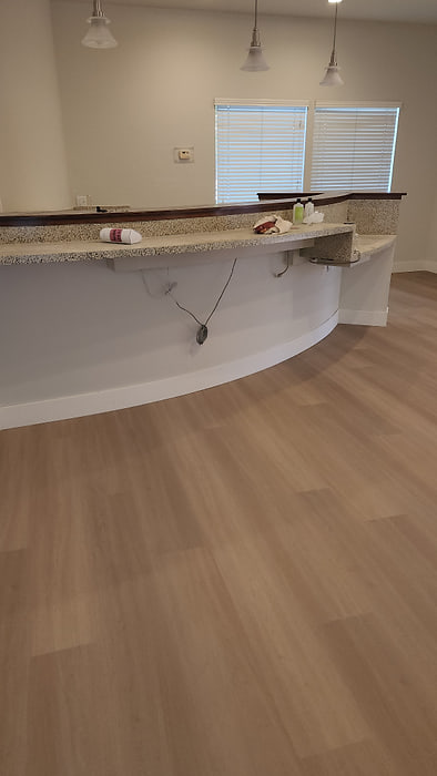 Vinyl plank flooring scribed to follow the base of a curved counter