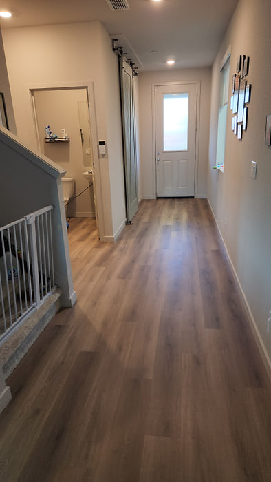 Entry hallway and stair landing finished in wood-look vinyl plank