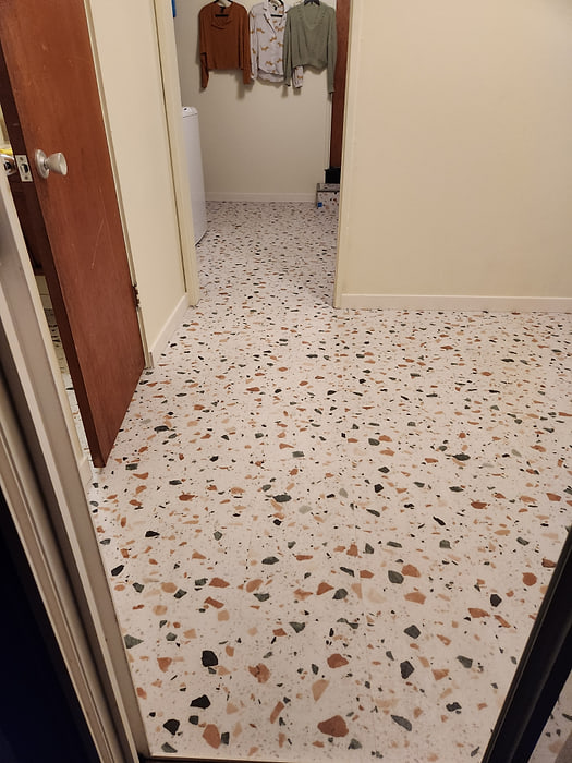 Terrazzo-look sheet vinyl flooring running down a Sacramento hallway