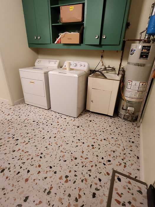 Laundry room with terrazzo-look waterproof vinyl fitted around appliances